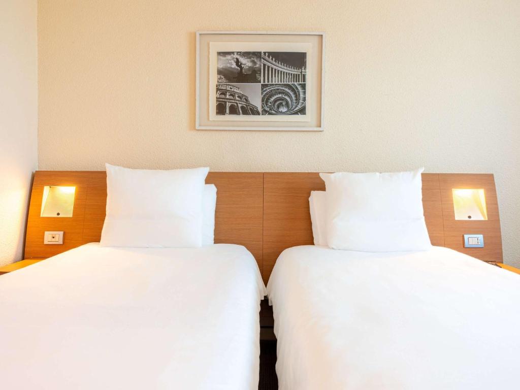 Postel nebo postele na pokoji v ubytování Novotel Roma Est