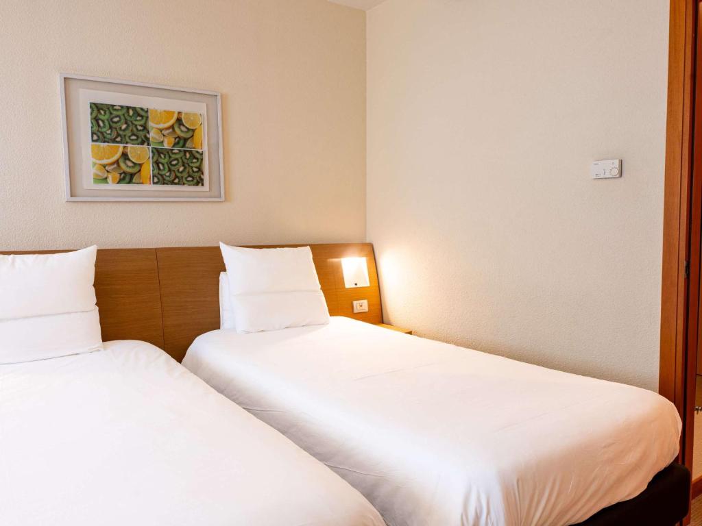 Postel nebo postele na pokoji v ubytování Novotel Roma Est