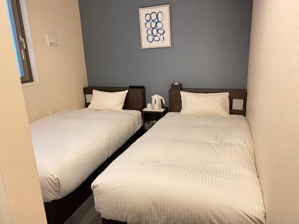 Postel nebo postele na pokoji v ubytování Floral Hotel · SakaisuJi-Honmachi Osaka