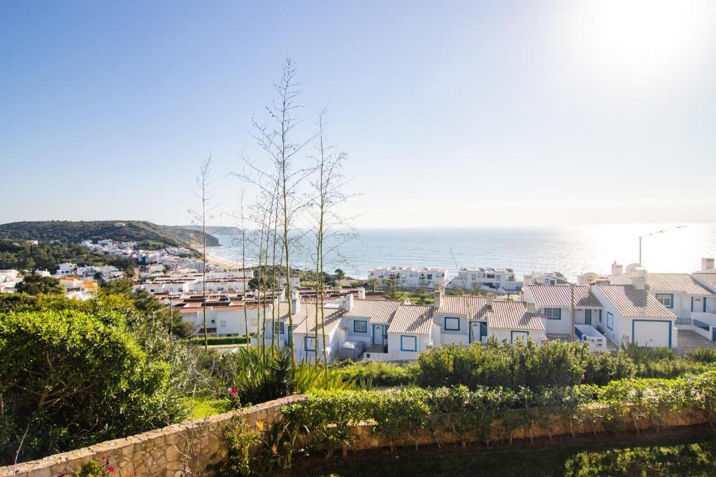 a view of a city with houses and the ocean at The View – Santo António Villas, Golf & Spa in Salema