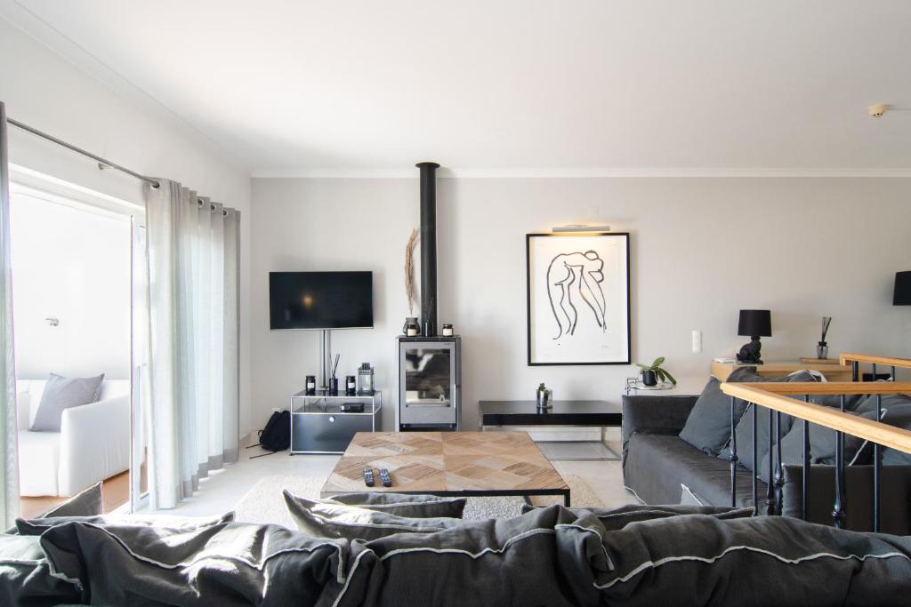 a living room with a couch and a table at The View – Santo António Villas, Golf & Spa in Salema