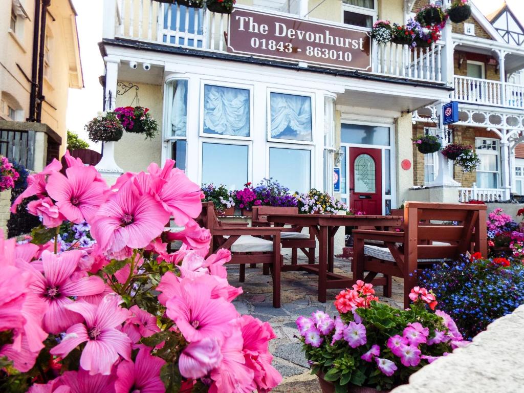 a restaurant with pink flowers in front of a building at The Devonhurst in Broadstairs