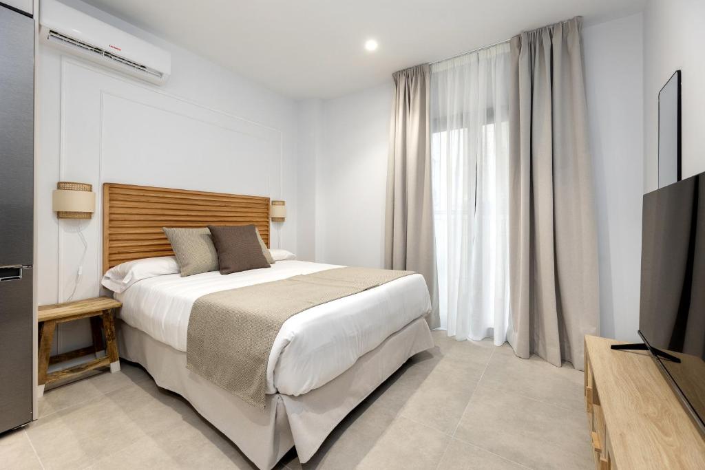 Postel nebo postele na pokoji v ubytování Nest Flats Triunfo