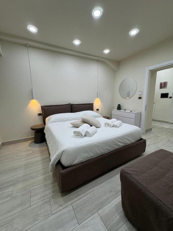 a bedroom with a large bed with towels on it at Tecla Apartment in Reggio di Calabria