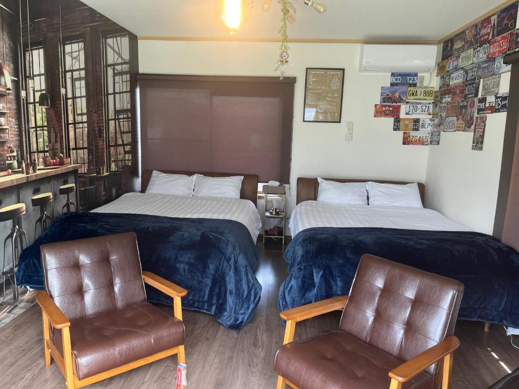 Postel nebo postele na pokoji v ubytování Yokkaichi Guest House