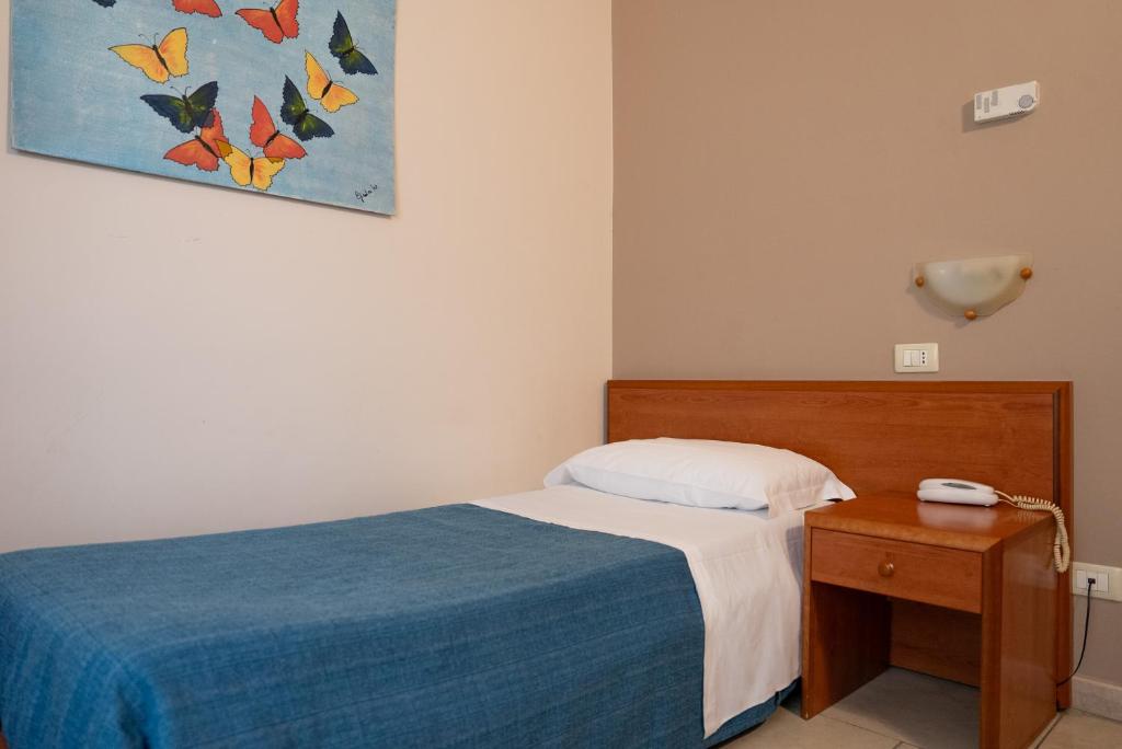 Łóżko lub łóżka w pokoju w obiekcie Hotel Belvedere