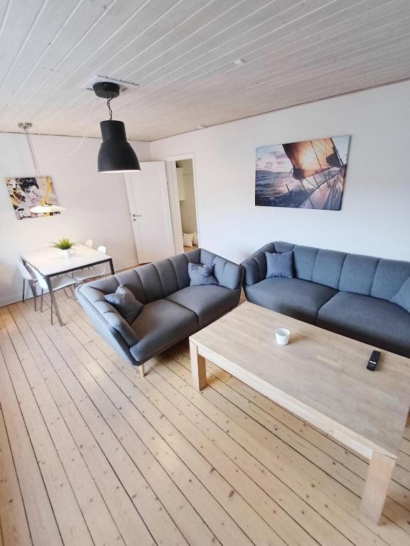 a living room with a couch and a coffee table at Bright and central city apartment near Aalborg Business School in Aalborg
