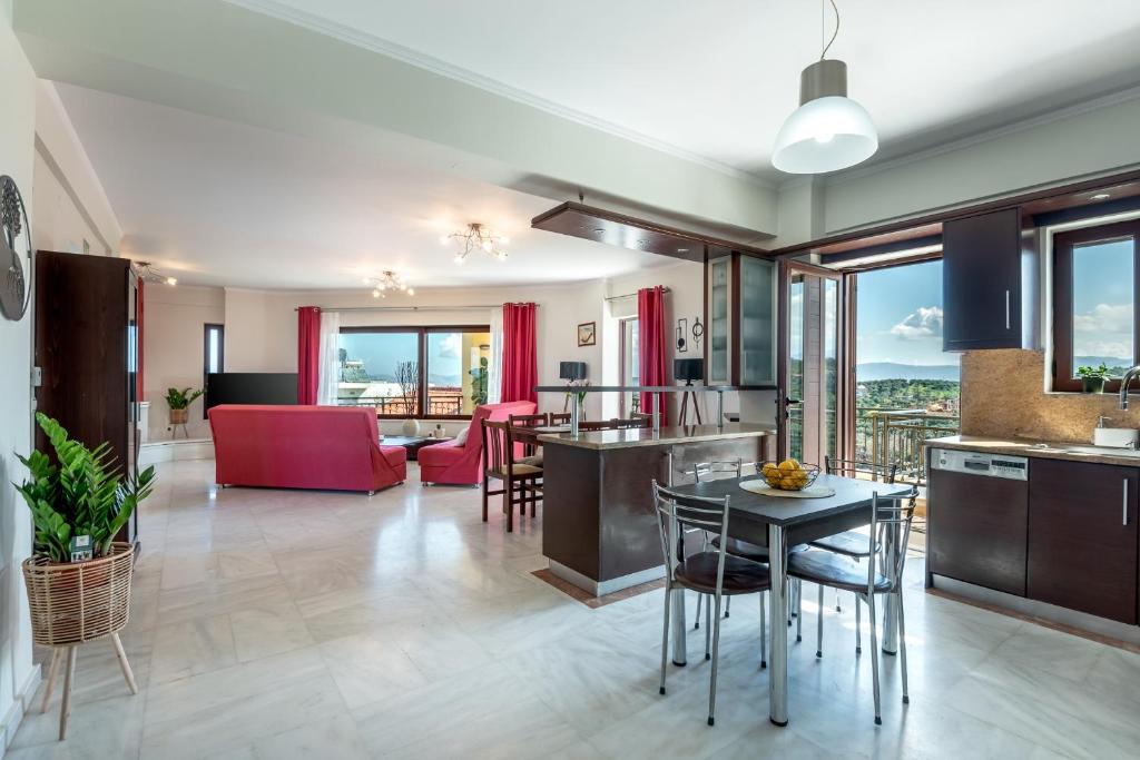 a kitchen and living room with a table and chairs at Sunlit sea view apartments in Stalos