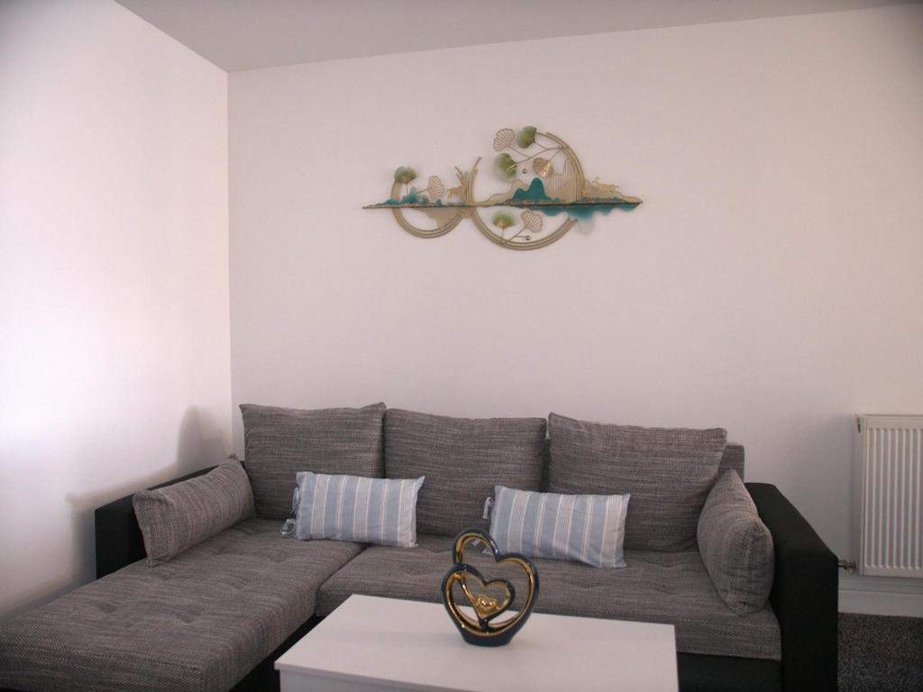 a living room with a couch and a table at Stylish 4 Bd Ft LDN Parking in London