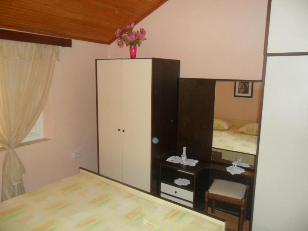 a bedroom with a bed and a dresser and a mirror at Danko Apartments in Brna