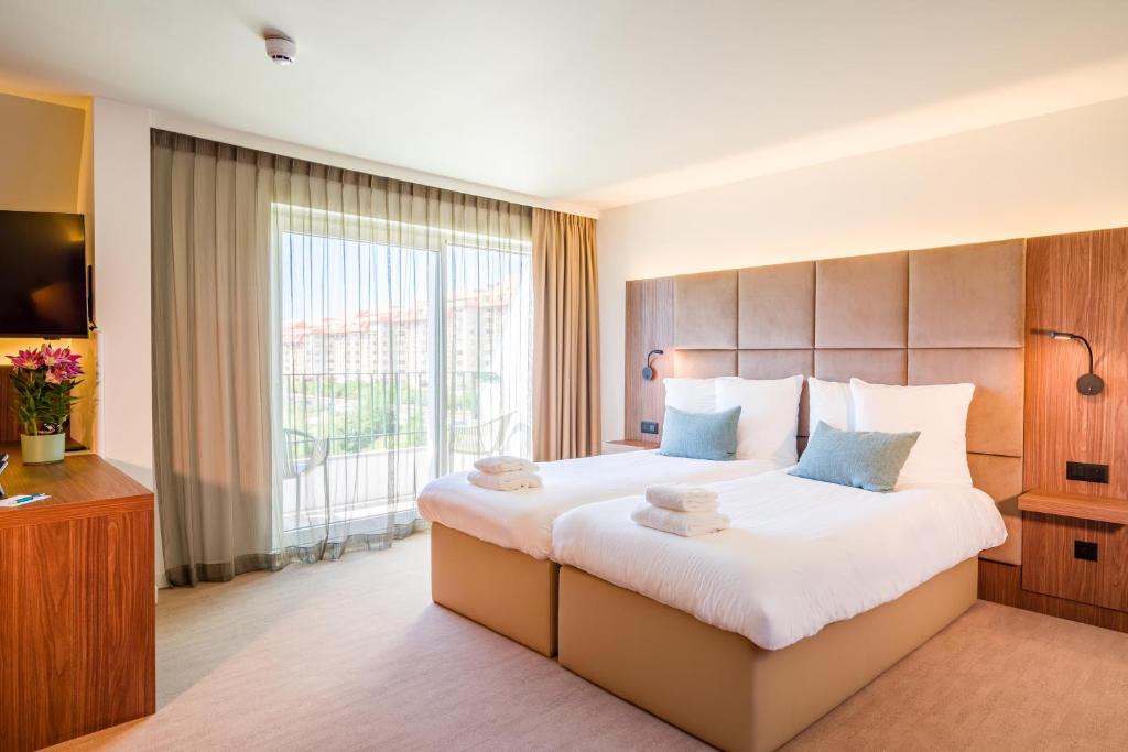 Postel nebo postele na pokoji v ubytování Dune Hotel Nieuwpoort
