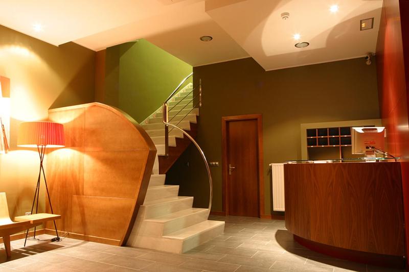 a room with a spiral staircase and a desk at AB Murias Blancas in Villaviciosa