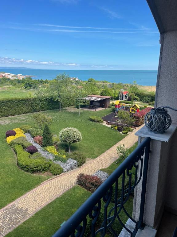 a balcony with a view of a garden at Sunset in Chernomorets