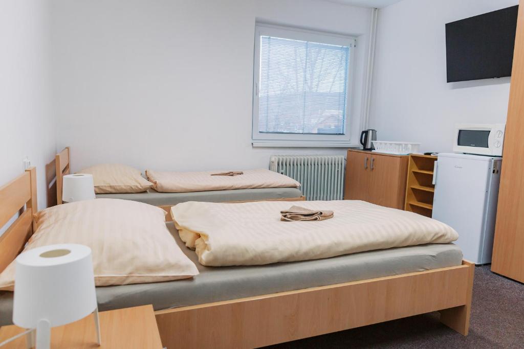 Postel nebo postele na pokoji v ubytování Turistická ubytovňa Zuberec pod Grápou