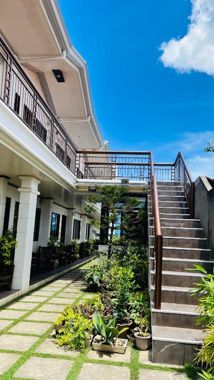 a building with stairs and plants in a courtyard at Residencia Lourdes in Mactan
