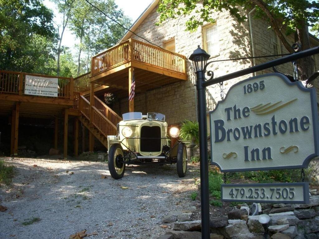 an old car parked in front of a brownstone inn at Brownstone Innkeeper Iconic Location Walk to Dwntn in Eureka Springs