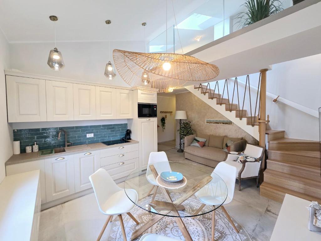 a kitchen and living room with a table and chairs at Marine Bliss in Savudrija