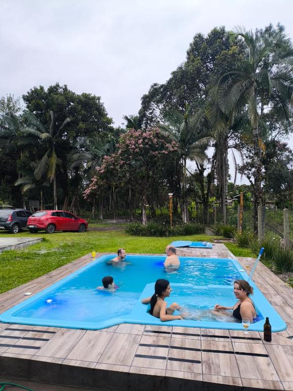 a group of children playing in a swimming pool at Rancho Bertotti in Guaratuba