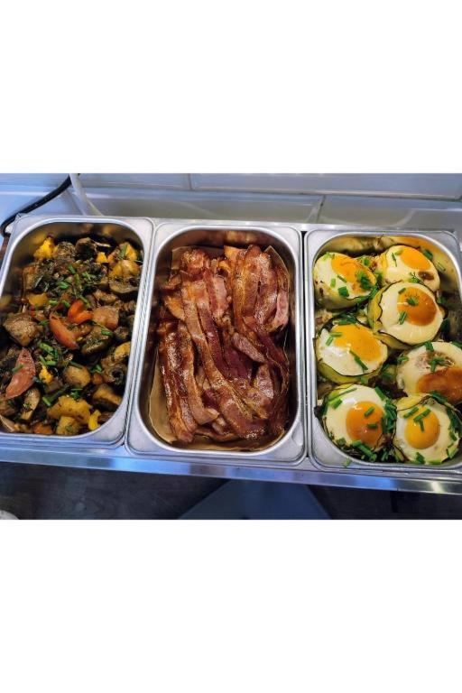 a tray of food with eggs and meat and vegetables at Greg&Tom Beer House Hostel in Krakow