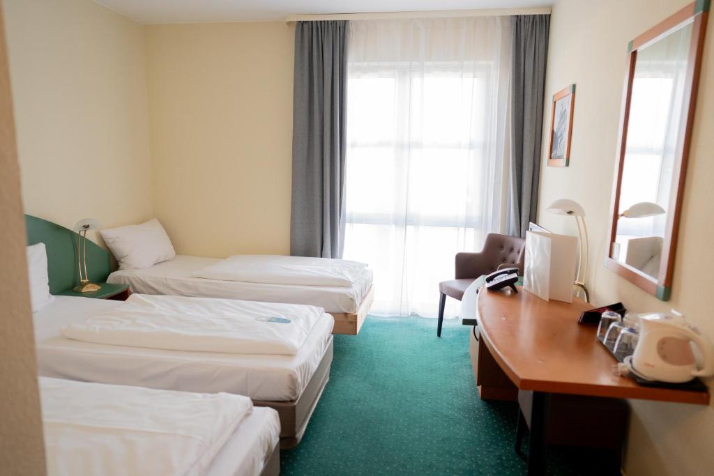 Postel nebo postele na pokoji v ubytování Trip Inn Hotel Dasing-Augsburg
