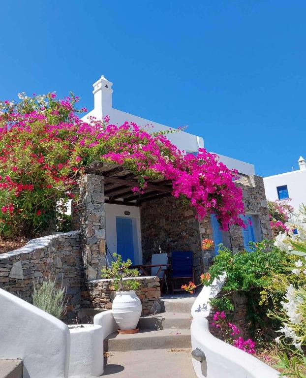 a house with pink flowers on the side of it at Maridina House in Livadi