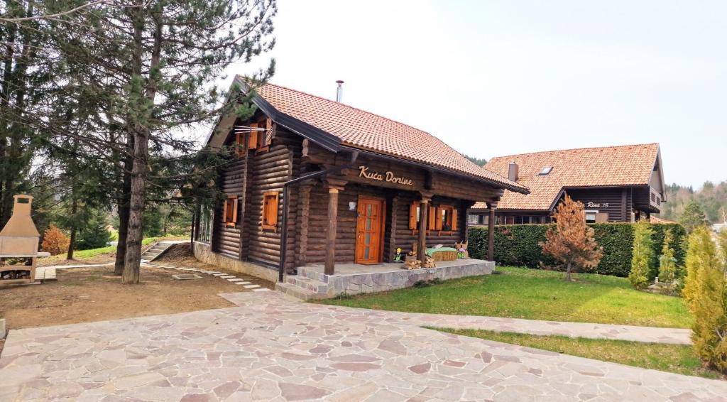 a small wooden house with a porch on a yard at Haus Dorine in Fužine - Haus für 6 Personen in Fužine