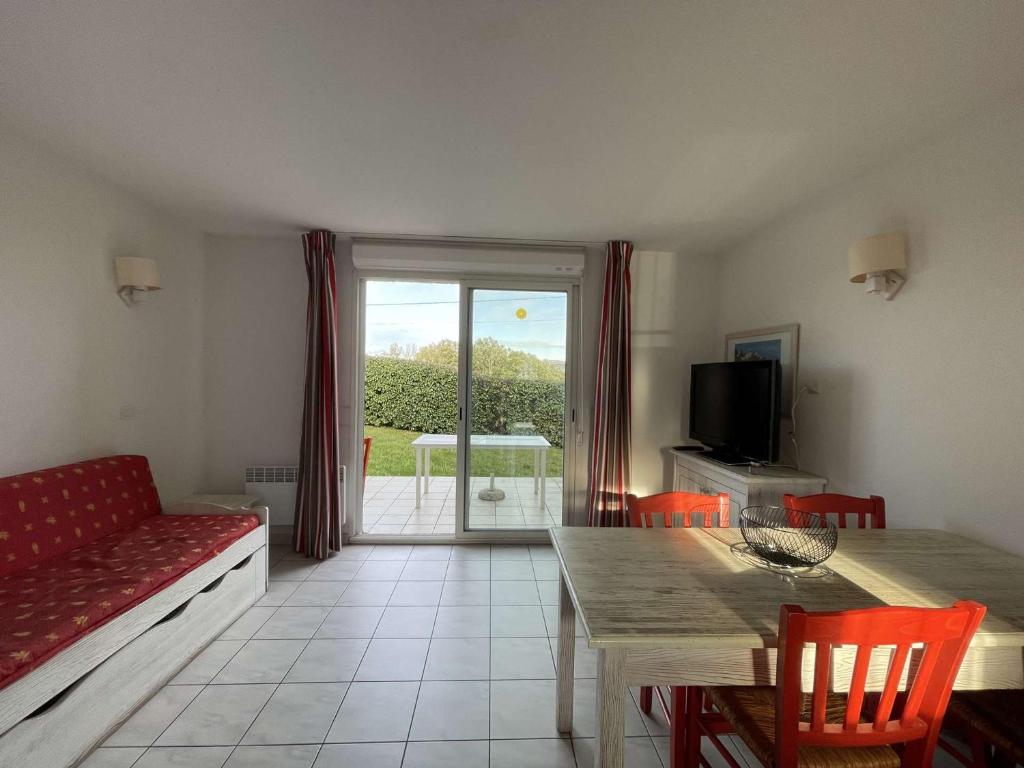 a living room with a couch and a table and chairs at Maison Duplex avec Piscines à Salavas - 6 Personnes, Animaux Admis, Parking, Terrasse et WiFi - FR-1-382-136 in Salavas
