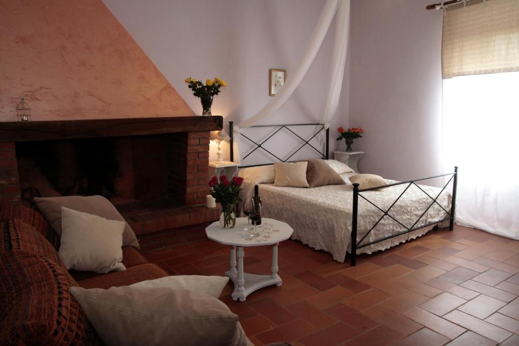 a living room with a bed and a fireplace at Borgo al Cielo - Albergo Diffuso in Suvereto
