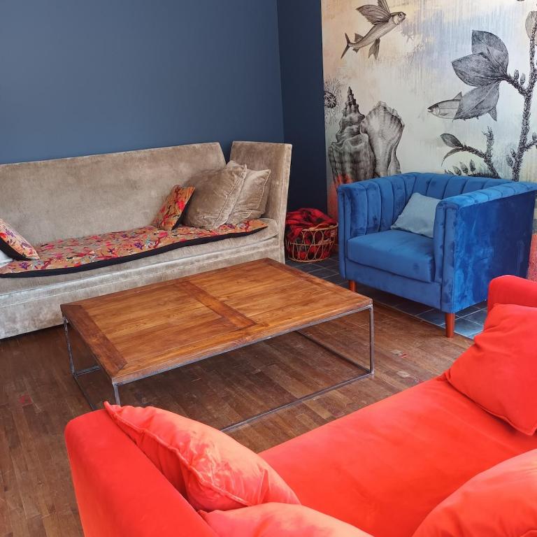 a living room with two couches and a coffee table at Maison 14 personnes in Plozévet