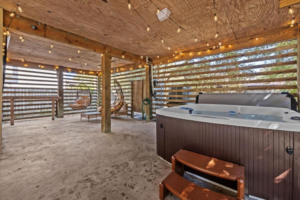 a large room with a hot tub in a building at Mins to Beach Hot Tub Projector Shuffleboard in Kill Devil Hills