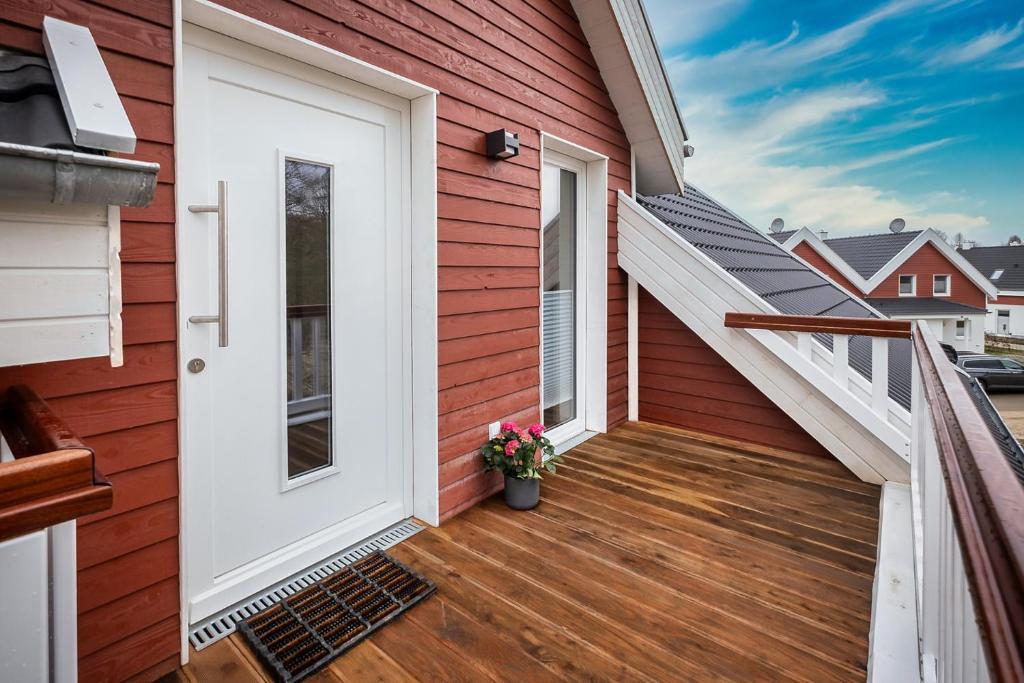 a house with a white door on a deck at VechteSchober in Nordhorn