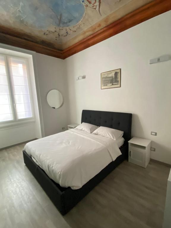 a bedroom with a large bed and a ceiling at Brera's Elite Apartment in Milan