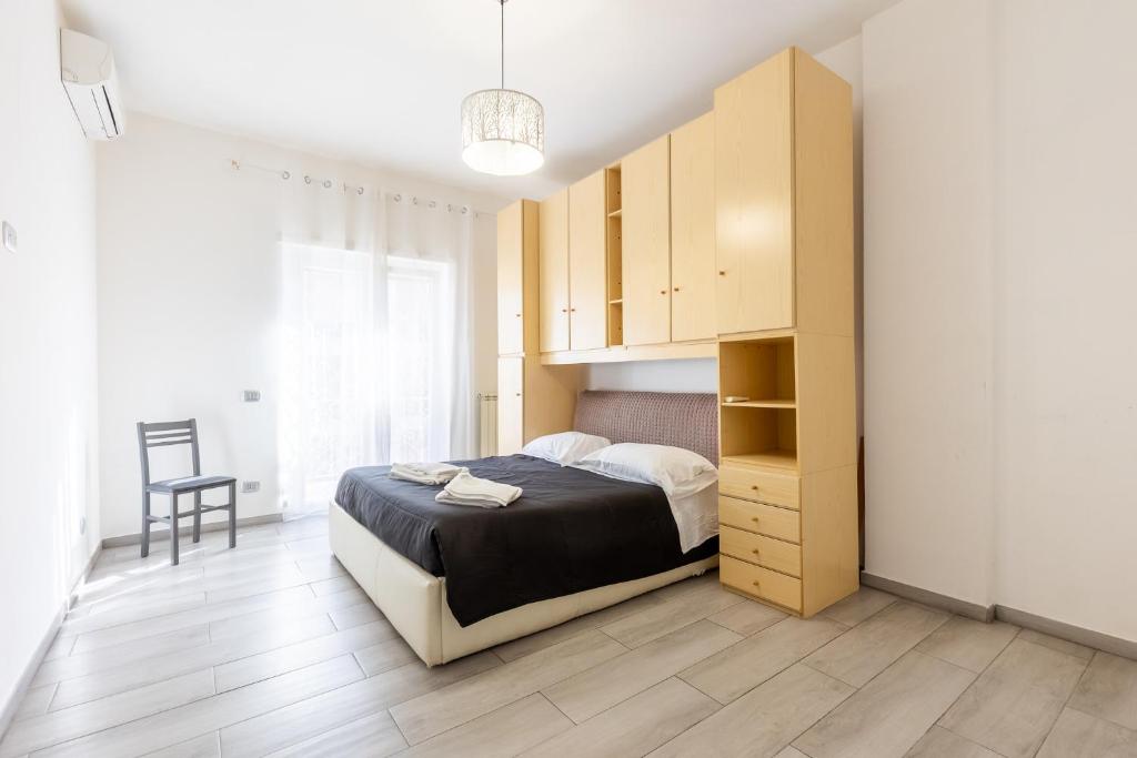Un dormitorio con una cama y un armario de madera. en Casa Vacanze Il Traghetto, en Lido di Ostia