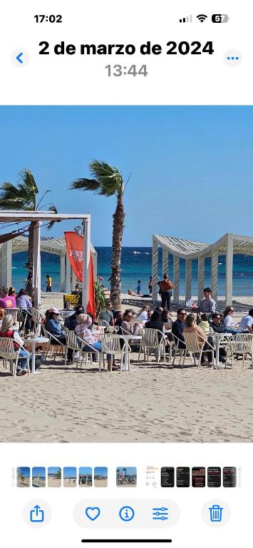 a group of people sitting in chairs on the beach at Alicante 20 in Alicante