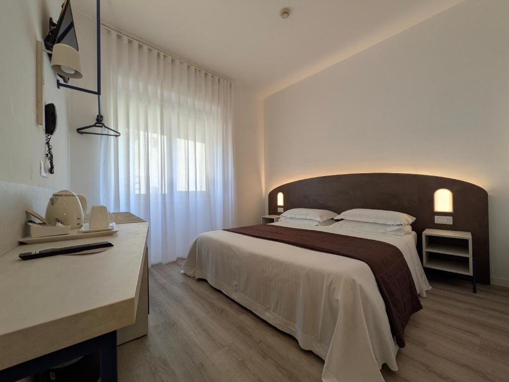 Postel nebo postele na pokoji v ubytování Hotel Piccolo