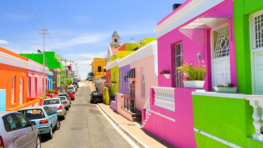 a row of colorful houses on a city street at The Famous Bokaap Villa in Cape Town
