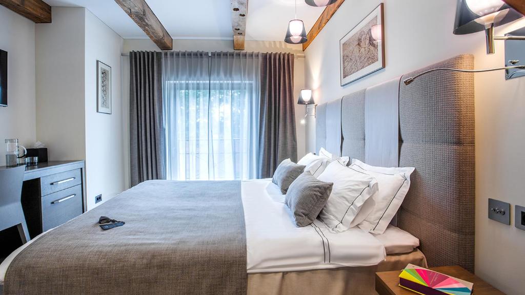 Postel nebo postele na pokoji v ubytování Michaelson Boutique Hotel & SPA Brícoła