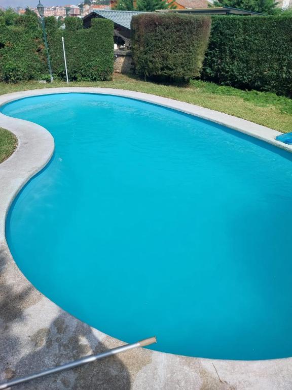 a blue swimming pool with a curved curb at Vigo Barreiro in Vigo