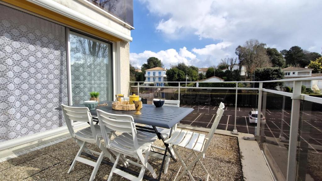 une table bleue et des chaises sur un balcon dans l'établissement Vaux sur Mer - APPARTEMENT résidence LES TROIS MOUSQUETAIRES - Plage de Nauzan, à Vaux-sur-Mer