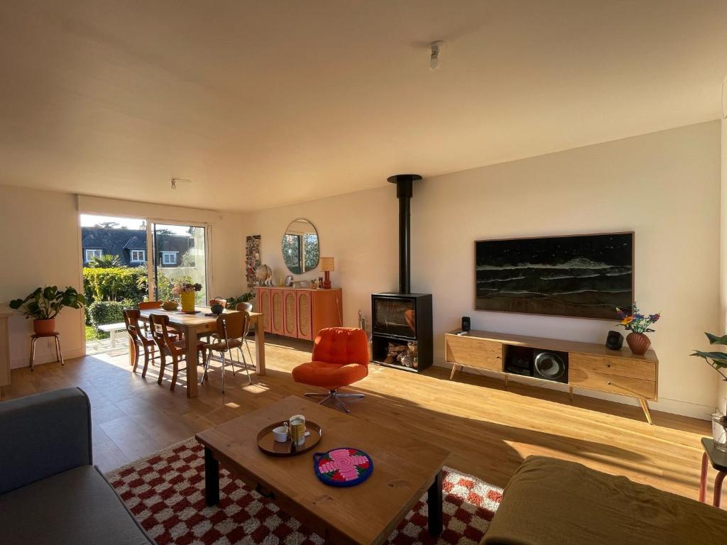 un salon avec une grande télévision à écran plat dans l'établissement Maison T4 + Jardin SO, plages et commerces à pied, à Saint-Malo