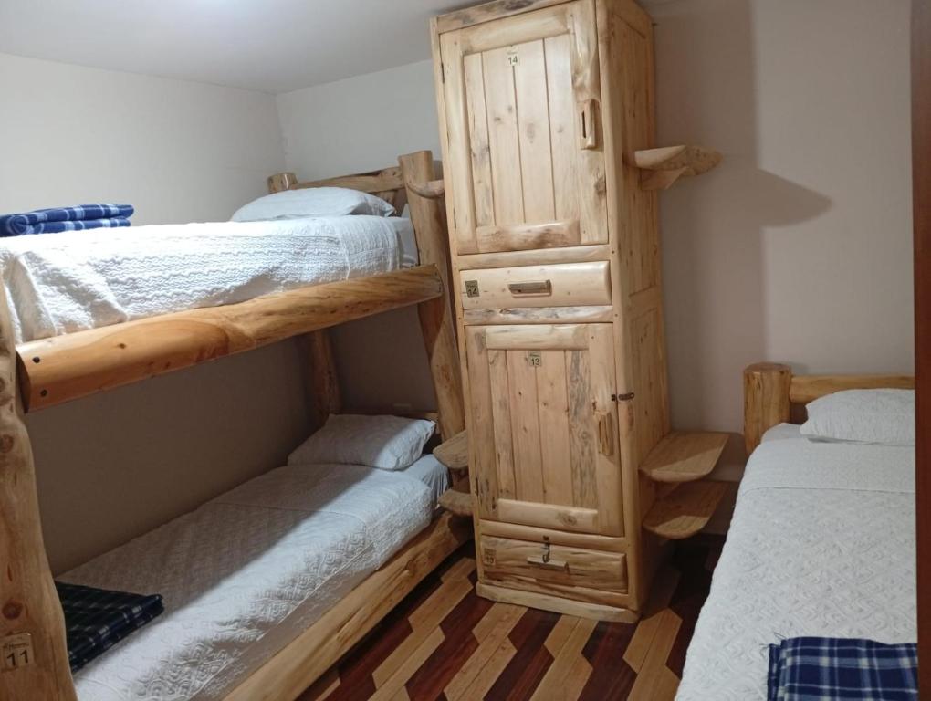 Postel nebo postele na pokoji v ubytování Hotel Maderanegra By Huasicama