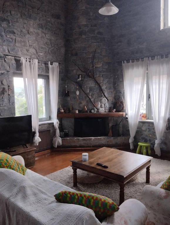 a living room with a couch and a coffee table at Vitina Number 5 House in Vitina