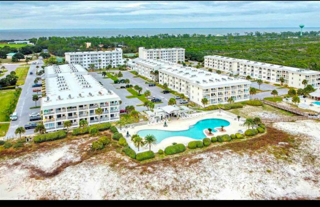 an aerial view of a resort with a pool at Stay beachy in Gulf Shores