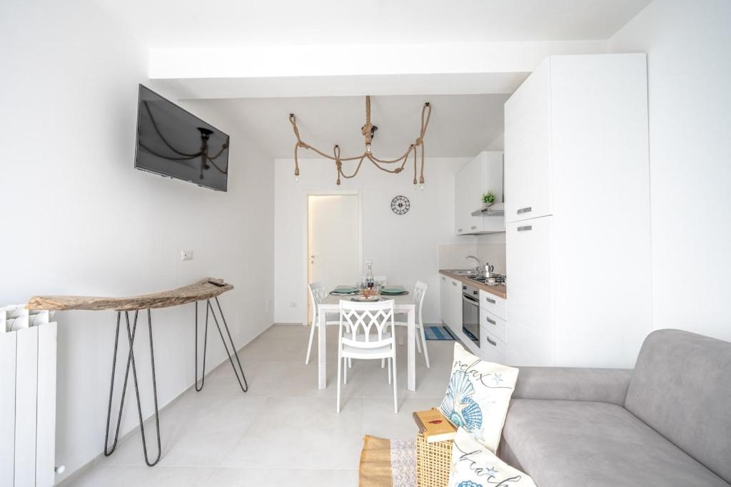 a living room with a couch and a table at Lulu Apartament in Civitanova Marche