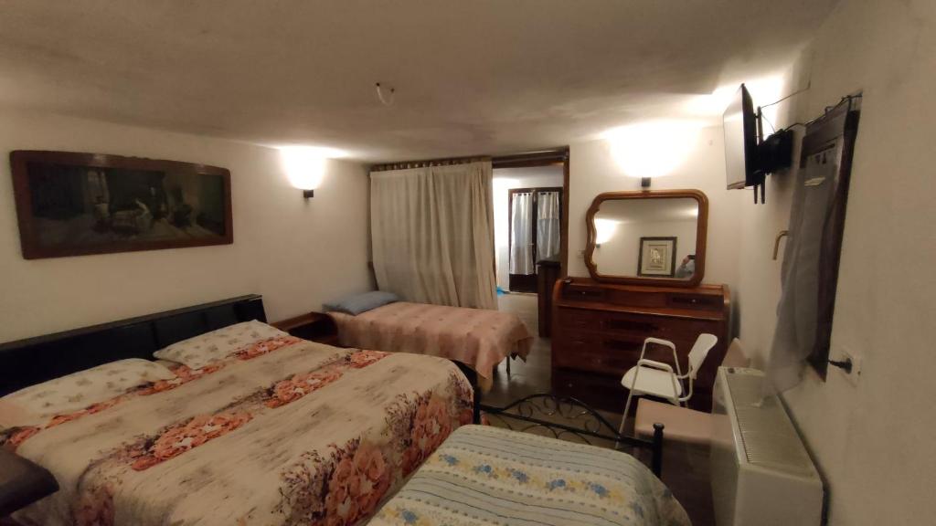 a hotel room with two beds and a mirror at Residence nel verde e nei trulli in Martina Franca