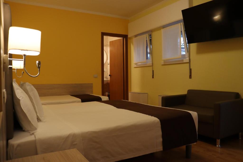 Postel nebo postele na pokoji v ubytování Hotel Montereale