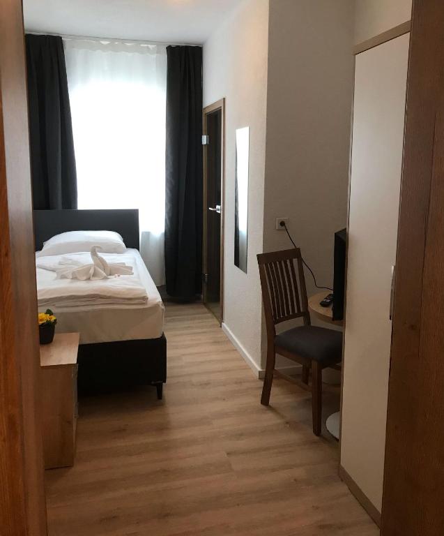 Postel nebo postele na pokoji v ubytování Hotel am Wasserturm