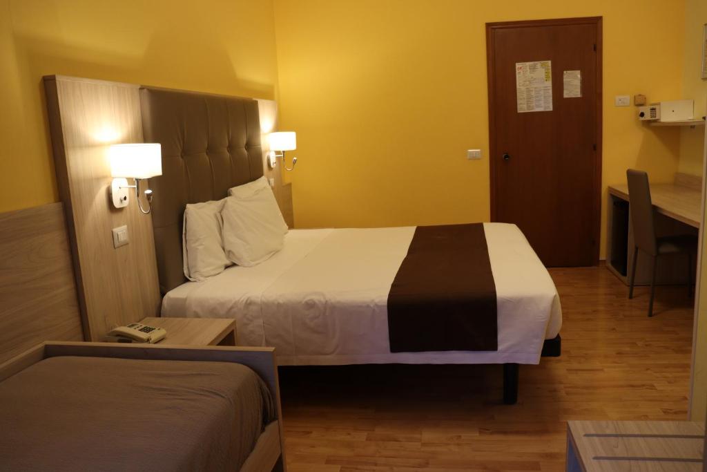 Postel nebo postele na pokoji v ubytování Hotel Montereale