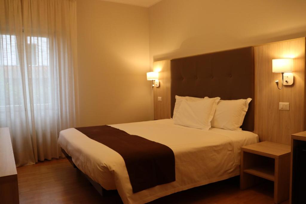 Postel nebo postele na pokoji v ubytování Hotel Montereale