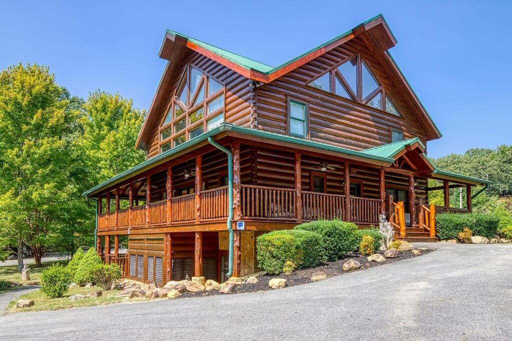 a large wooden house with a wrap around porch at Grand Lodge in Sevierville